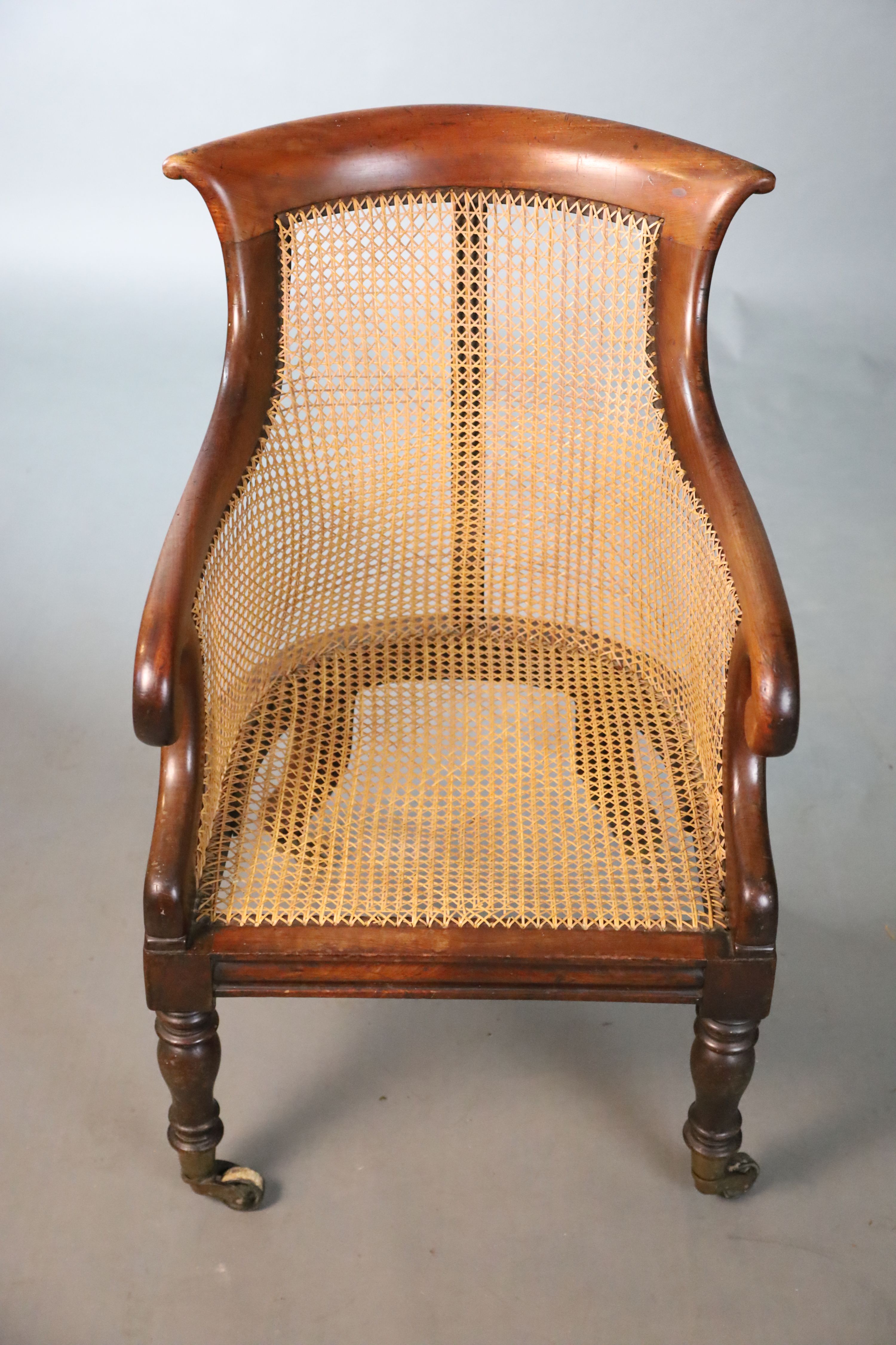 A Regency mahogany bergere armchair, W.58.5cm D.66cm H.89cm